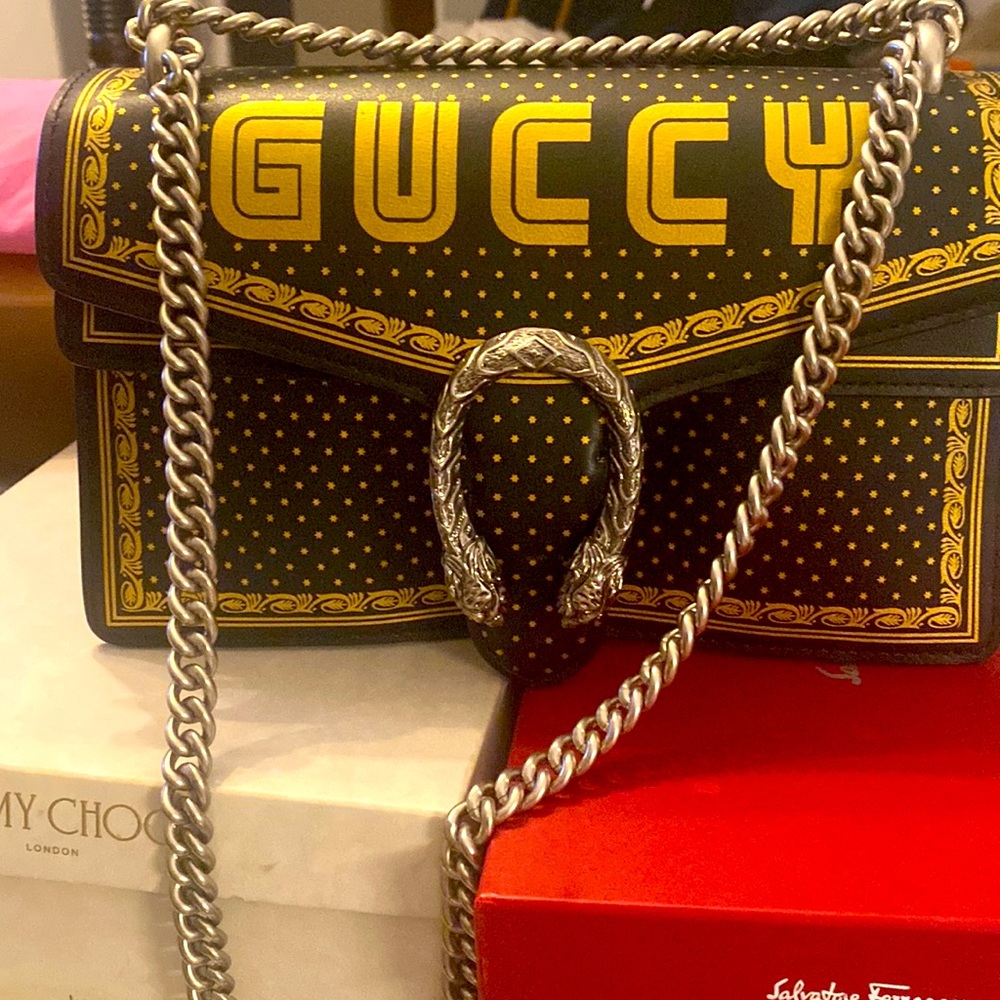 Guccy Dionysus Sega Letter, black and gold with silver chain.